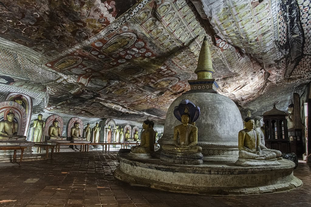 Buddha statues and ancient murals inside Dambulla Cave Temple in Sri Lanka