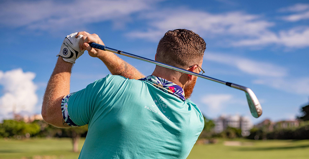 Guest swinging a golf club on a lush golf course during a Kawaiki Tours & Travels golf tour in Sri Lanka